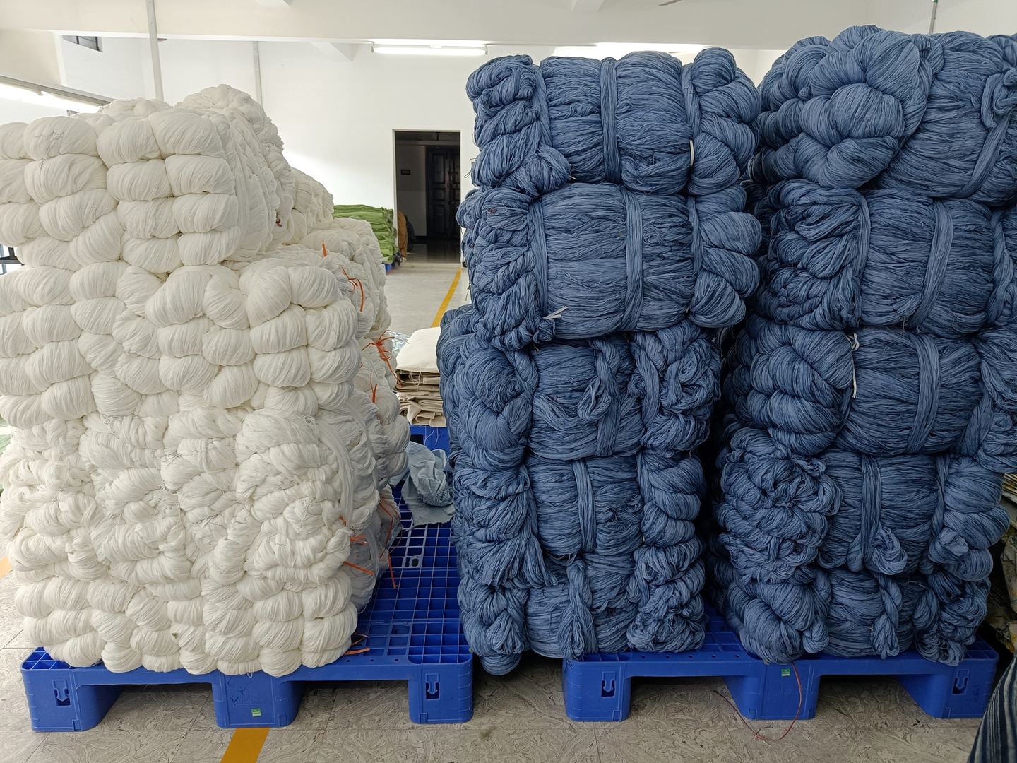Bales of bleached and indigo-dyed yarn in storage